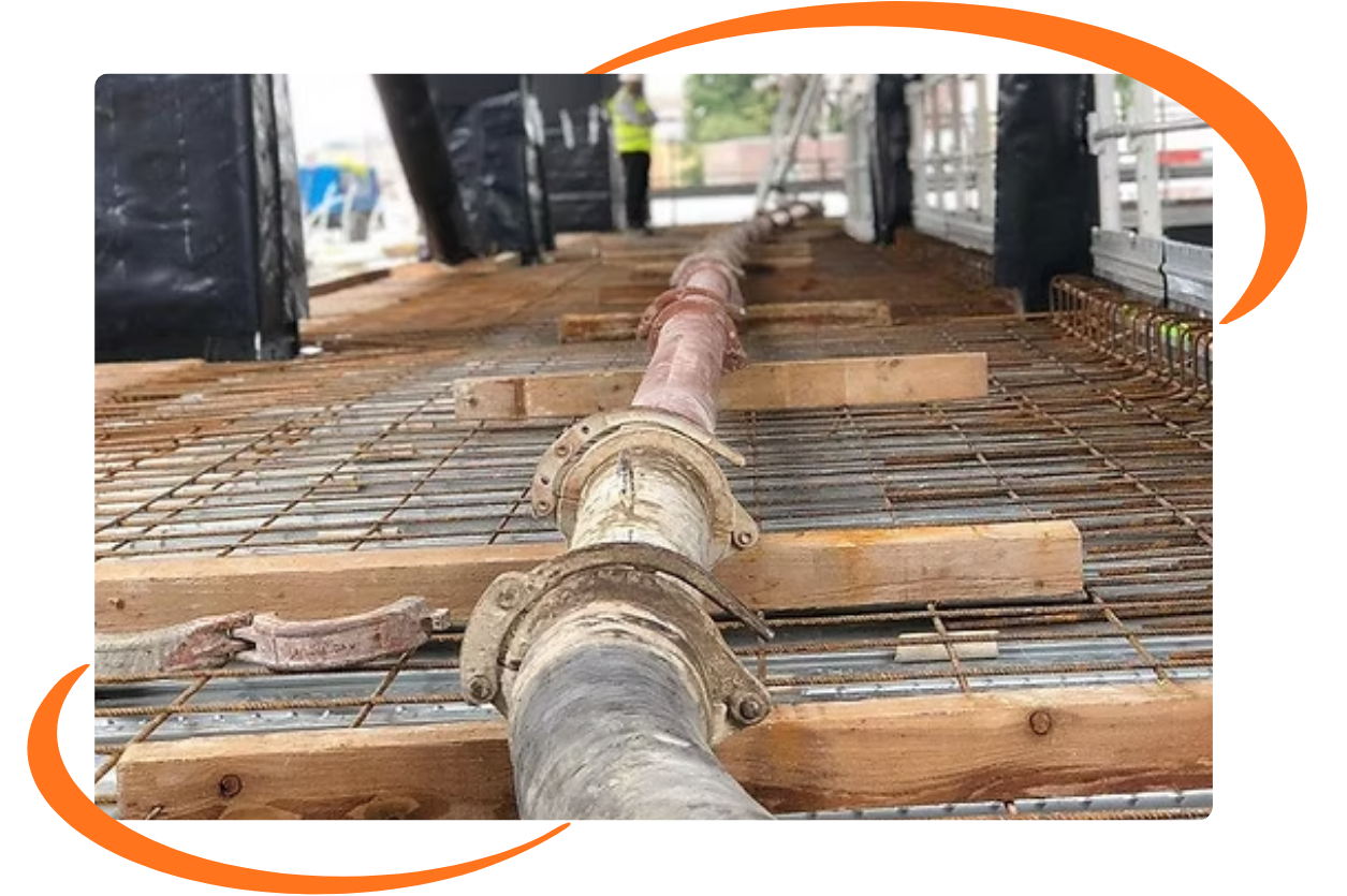 Concrete pump line running across a reinforced deck on site
