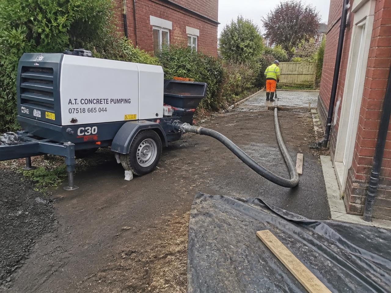 Compact concrete line pump on a residential driveway